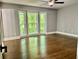 Bedroom with large bay window offering a scenic outdoor view and hardwood flooring at 1230 Sunderland Ne Ct, Brookhaven, GA 30319