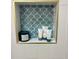 Close-up of a built-in shower niche featuring decorative blue tile and stylish storage at 1230 Sunderland Ne Ct, Brookhaven, GA 30319