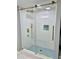 Modern shower boasts glass enclosure, gold hardware, and blue mosaic floor at 1230 Sunderland Ne Ct, Brookhaven, GA 30319