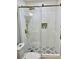 Modern bathroom showcasing glass-enclosed shower with unique tile flooring and a convenient built-in niche at 1230 Sunderland Ne Ct, Brookhaven, GA 30319