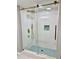 Modern shower with gold hardware, glass door and blue mosaic floor tiles at 1230 Sunderland Ne Ct, Brookhaven, GA 30319