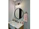 Bathroom features wood vanity, white marble, bronze hardware, and storage at 1230 Sunderland Ne Ct, Brookhaven, GA 30319