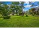 Expansive backyard with lush green grass and mature trees, and a rustic shed at 14300 Veterans Memorial Highway, Villa Rica, GA 30180