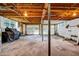 Unfinished basement featuring exposed ceiling joists, concrete floor, and double wide garage doors at 14300 Veterans Memorial Highway, Villa Rica, GA 30180