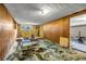Unique basement featuring paneled walls and abstract floors, offering potential for various uses at 14300 Veterans Memorial Highway, Villa Rica, GA 30180