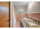 Vintage bathroom featuring a double sink vanity, tiled wall, and shower at 14300 Veterans Memorial Highway, Villa Rica, GA 30180