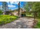 Exterior shot of a two-story home with a carport and an attached garage with green doors at 14300 Veterans Memorial Highway, Villa Rica, GA 30180