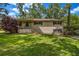 Charming two-story brick home with a well-maintained front yard and mature trees at 14300 Veterans Memorial Highway, Villa Rica, GA 30180