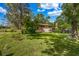 Well-maintained front yard features lush green grass and mature trees in a peaceful setting at 14300 Veterans Memorial Highway, Villa Rica, GA 30180