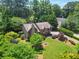 Expansive aerial view of a beautiful home surrounded by lush greenery and mature trees providing privacy at 150 Victoria Sta, Woodstock, GA 30189