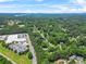 Expansive aerial view featuring a neighborhood near a commercial area and lush natural landscape with lake views at 150 Victoria Sta, Woodstock, GA 30189
