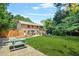 Expansive backyard featuring lush lawn, mature trees, patio, and picnic table for outdoor enjoyment at 150 Victoria Sta, Woodstock, GA 30189