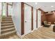 Hallway with a carpeted staircase and dark trim around white paneled doors at 150 Victoria Sta, Woodstock, GA 30189