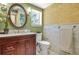 Bathroom with wood vanity, marble countertop, neutral patterned wallpaper, and decorative mirror at 150 Victoria Sta, Woodstock, GA 30189