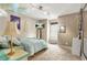 Cozy bedroom featuring neutral walls, carpet, unique lighting fixture, and a mounted television at 150 Victoria Sta, Woodstock, GA 30189