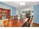 Bright dining area with hardwood table and chairs, with view into updated kitchen with stainless steel appliances at 150 Victoria Sta, Woodstock, GA 30189