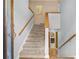 Welcoming entryway with a carpeted staircase, wood railings, and an open floor plan that invites exploration at 150 Victoria Sta, Woodstock, GA 30189