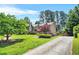 Charming two-story home with mature trees on a well-manicured lawn provides a desirable curb appeal at 150 Victoria Sta, Woodstock, GA 30189