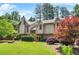 Charming two-story home with wood siding, beautiful landscaping, and mature trees provides curb appeal at 150 Victoria Sta, Woodstock, GA 30189