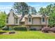 Charming two-story home with wood siding, beautiful landscaping, and mature trees in a desirable neighborhood at 150 Victoria Sta, Woodstock, GA 30189