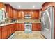 Updated kitchen featuring stainless steel appliances, granite countertops, stone backsplash and custom wood cabinets at 150 Victoria Sta, Woodstock, GA 30189