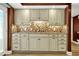 Basement kitchenette with ample cabinets, tile backsplash, and neutral countertops at 150 Victoria Sta, Woodstock, GA 30189