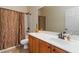 Well-lit bathroom featuring a shower-tub combo with a stylish bronze shower curtain and vanity with white countertops at 1945 Bay Beauty Ln # 10, Austell, GA 30106