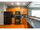 Bright kitchen featuring wood cabinets, black appliances, and hardwood floors at 1945 Bay Beauty Ln # 10, Austell, GA 30106