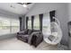 Bright living room with neutral colors, large windows, comfortable seating and unique pod chair at 1945 Bay Beauty Ln # 10, Austell, GA 30106