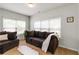Inviting living room with a plush brown sofa, bright natural light, and a cozy atmosphere for relaxation at 1945 Bay Beauty Ln # 10, Austell, GA 30106