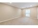 Spacious bedroom featuring a window and neutral carpeting at 28106 Plantation Ne Dr, Atlanta, GA 30324