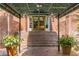 Stairway to building entrance under a canopy with brick columns and planters at 28106 Plantation Ne Dr, Atlanta, GA 30324