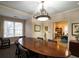 Bright conference room features a large table under an ornate chandelier, next to an office with a bookshelf at 28106 Plantation Ne Dr, Atlanta, GA 30324