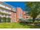 Multi-story brick building with balconies, a green awning, and a well-manicured lawn at 28106 Plantation Ne Dr, Atlanta, GA 30324