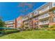 Beautiful exterior of the building featuring balconies, lush green lawn, and mature trees at 28106 Plantation Ne Dr, Atlanta, GA 30324