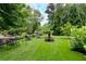 Serene landscaped garden with sitting areas, benches, and lush green lawn at 28106 Plantation Ne Dr, Atlanta, GA 30324
