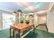 Hallway view showcasing sconces and wood table with fresh floral arrangement and 'exit' sign at 28106 Plantation Ne Dr, Atlanta, GA 30324