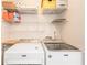 Bright laundry room featuring modern Maytag washer and dryer with wire rack shelving at 28106 Plantation Ne Dr, Atlanta, GA 30324