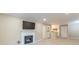 Open living room featuring a fireplace, kitchen view, and neutral carpeting at 28106 Plantation Ne Dr, Atlanta, GA 30324