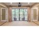 Main bedroom includes curtains and access to balcony with outdoor seating area at 28106 Plantation Ne Dr, Atlanta, GA 30324