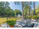 Pond with a fountain from a patio, featuring wrought iron railings and benches at 28106 Plantation Ne Dr, Atlanta, GA 30324