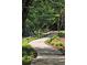 Scenic walking path winding through lush greenery and landscaped areas at 28106 Plantation Ne Dr, Atlanta, GA 30324