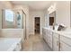 Bright bathroom with double vanity, large soaking tub, glass shower, and tile flooring at 3248 Shirecrest Ln, Dacula, GA 30019