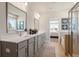 Elegant bathroom featuring a double vanity, a large mirror, walk-in shower, and tiled floors at 3248 Shirecrest Ln, Dacula, GA 30019