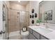 Bathroom features a glass shower, a gray vanity, and modern decor for a sleek and stylish design at 3248 Shirecrest Ln, Dacula, GA 30019