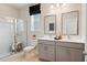 Bright bathroom with double vanity, framed mirrors, and a glass-enclosed shower at 3248 Shirecrest Ln, Dacula, GA 30019