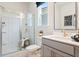 Well-lit bathroom with glass shower, modern vanity and fixtures, and window at 3248 Shirecrest Ln, Dacula, GA 30019