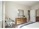 Bright bedroom featuring neutral walls, dresser, mirror, and decor creating a cozy and inviting space at 3248 Shirecrest Ln, Dacula, GA 30019