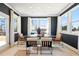Contemporary dining room featuring black walls, modern furniture, and large windows at 3248 Shirecrest Ln, Dacula, GA 30019
