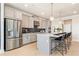 Modern kitchen with stainless steel appliances, an island with seating, and light gray cabinetry at 3248 Shirecrest Ln, Dacula, GA 30019